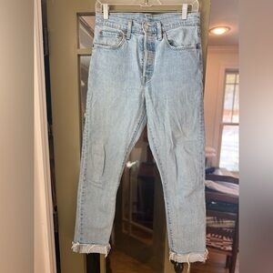 501s Levi’s Strauss Light Wash Blue Jeans with raw hem and button fly, W27 L30